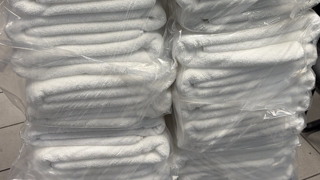 Stacks of fresh grooming towels, washed, folded and bagged