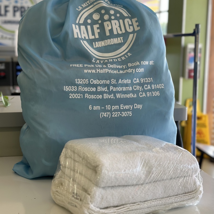 Half Price Laundry branded pickup bag with folded wash & fold