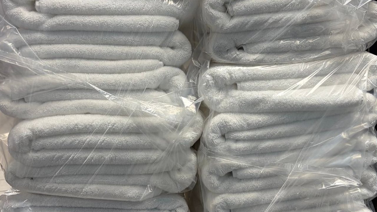 Hotel bath towels washed, folded and bagged by the stack