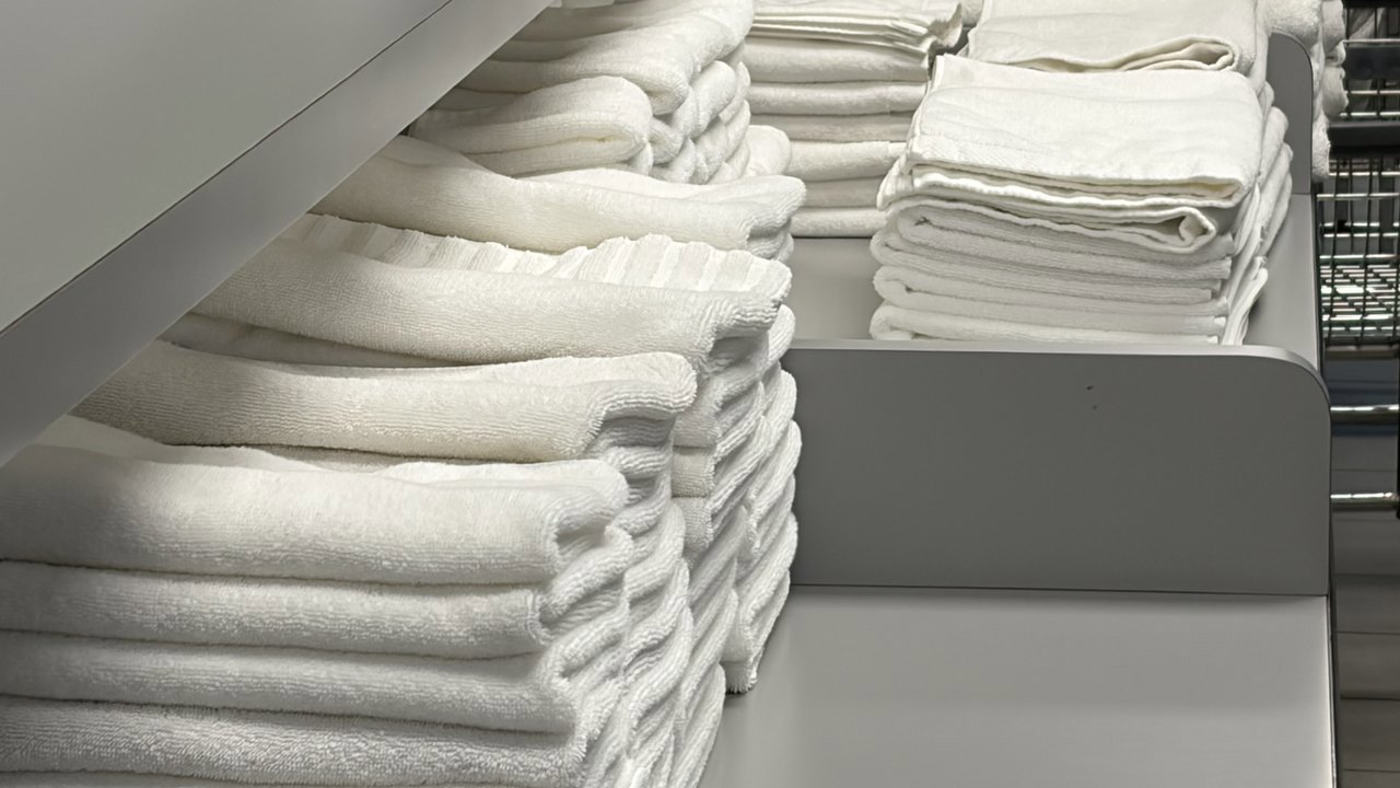 Stacks of fresh white towels, washed and folded